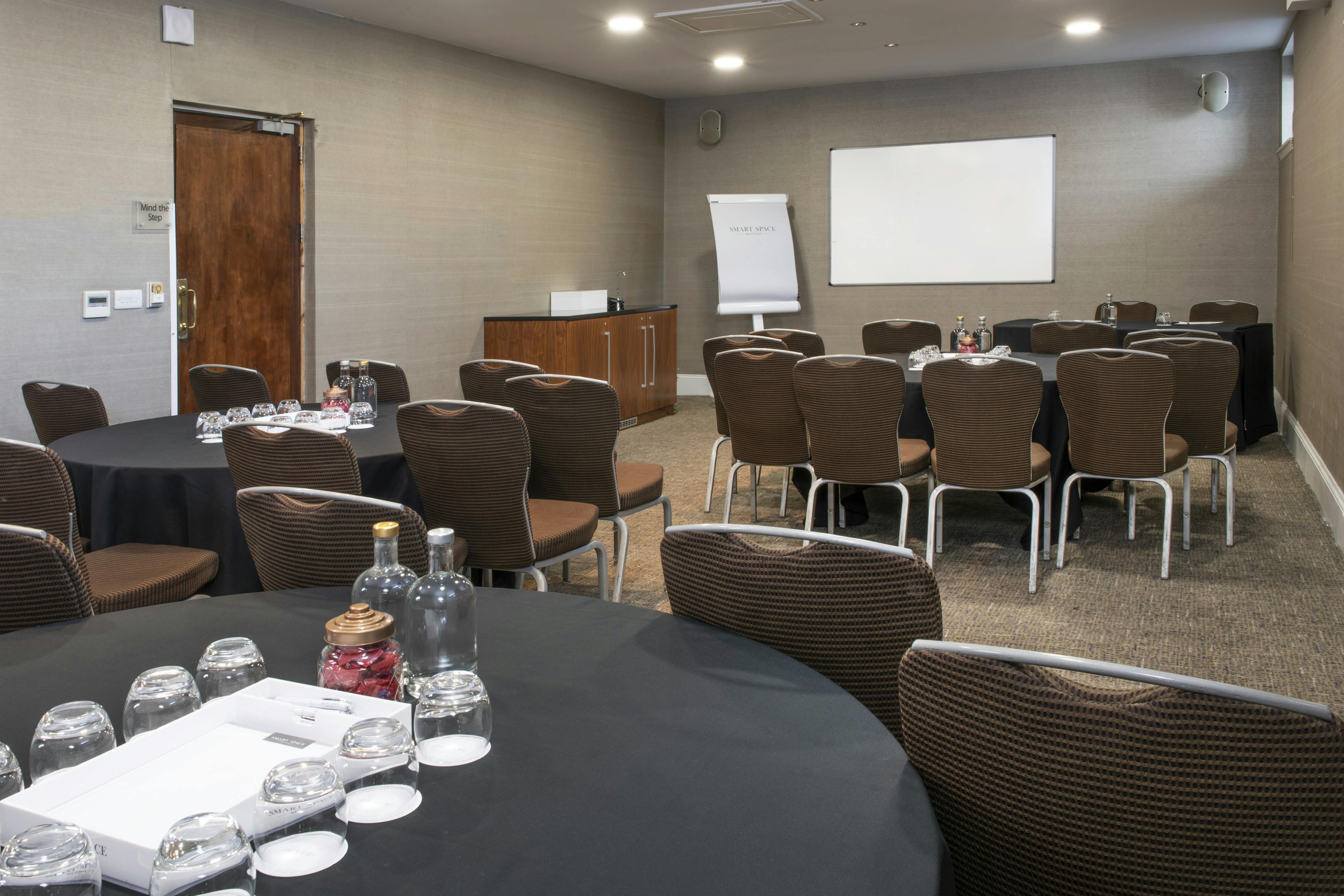 Holborn Suite meeting room with round tables, ideal for conferences and presentations.