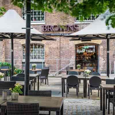 Outdoor dining at Cellar Bar, stylish terrace with umbrellas for networking events.