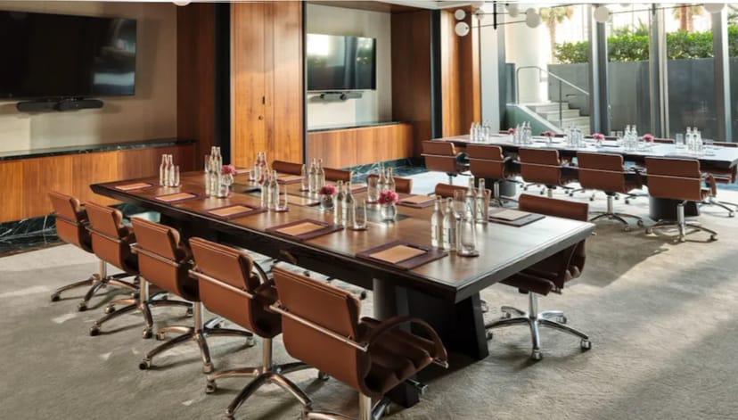 Modern conference room with large table, ideal for meetings and presentations.