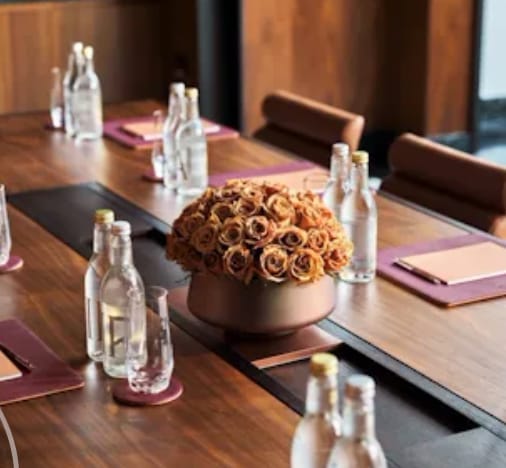 Elegant meeting table with floral centerpieces at The Lana for corporate events.
