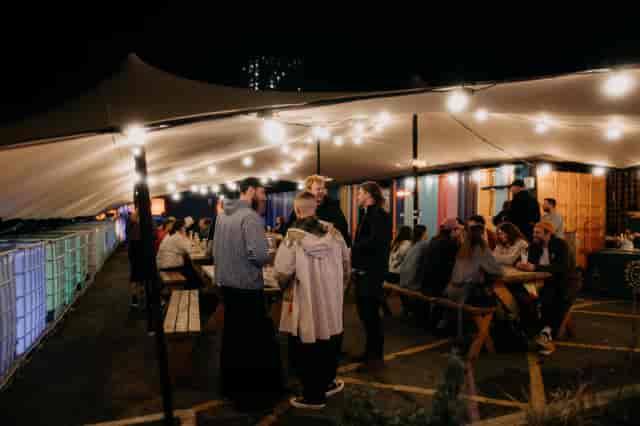 Outdoor event space with string lights, perfect for social gatherings and networking.