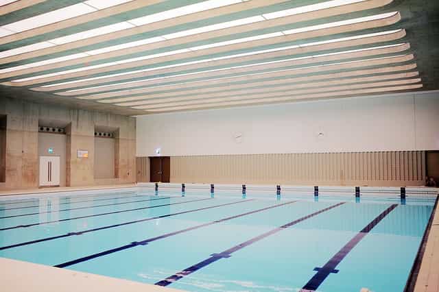 Indoor swimming pool at London Aquatics Centre, ideal for wellness retreats and events.