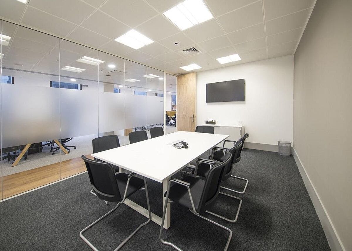 Modern meeting room for rent in Manchester with glass walls, ideal for events.