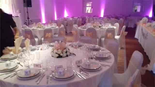 Elegant banquet hall with white linens, ideal for weddings and corporate events.