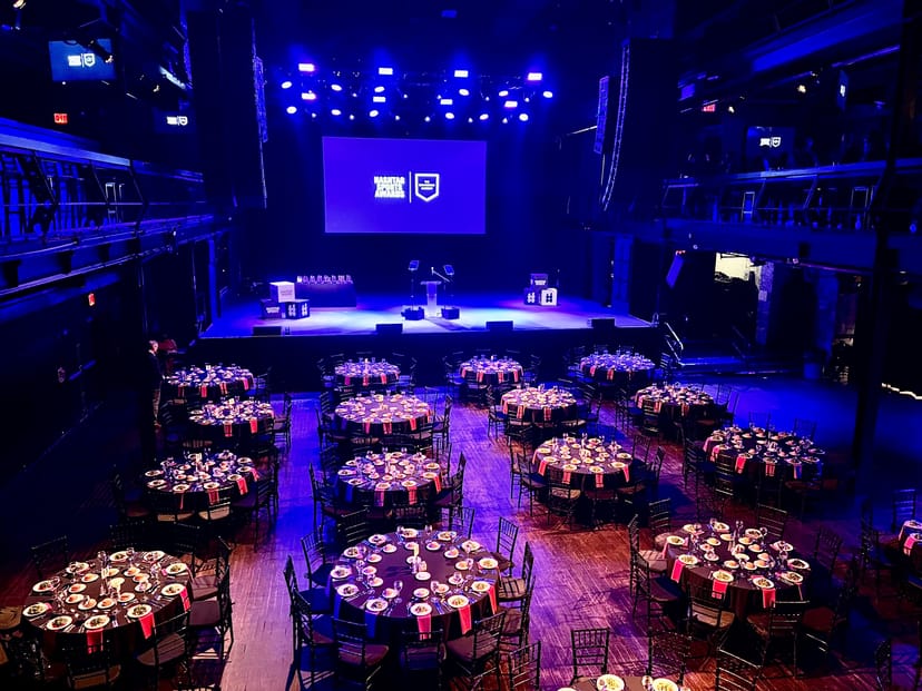 Elegant event space in Terminal 5 with round tables, ideal for conferences and gala dinners.