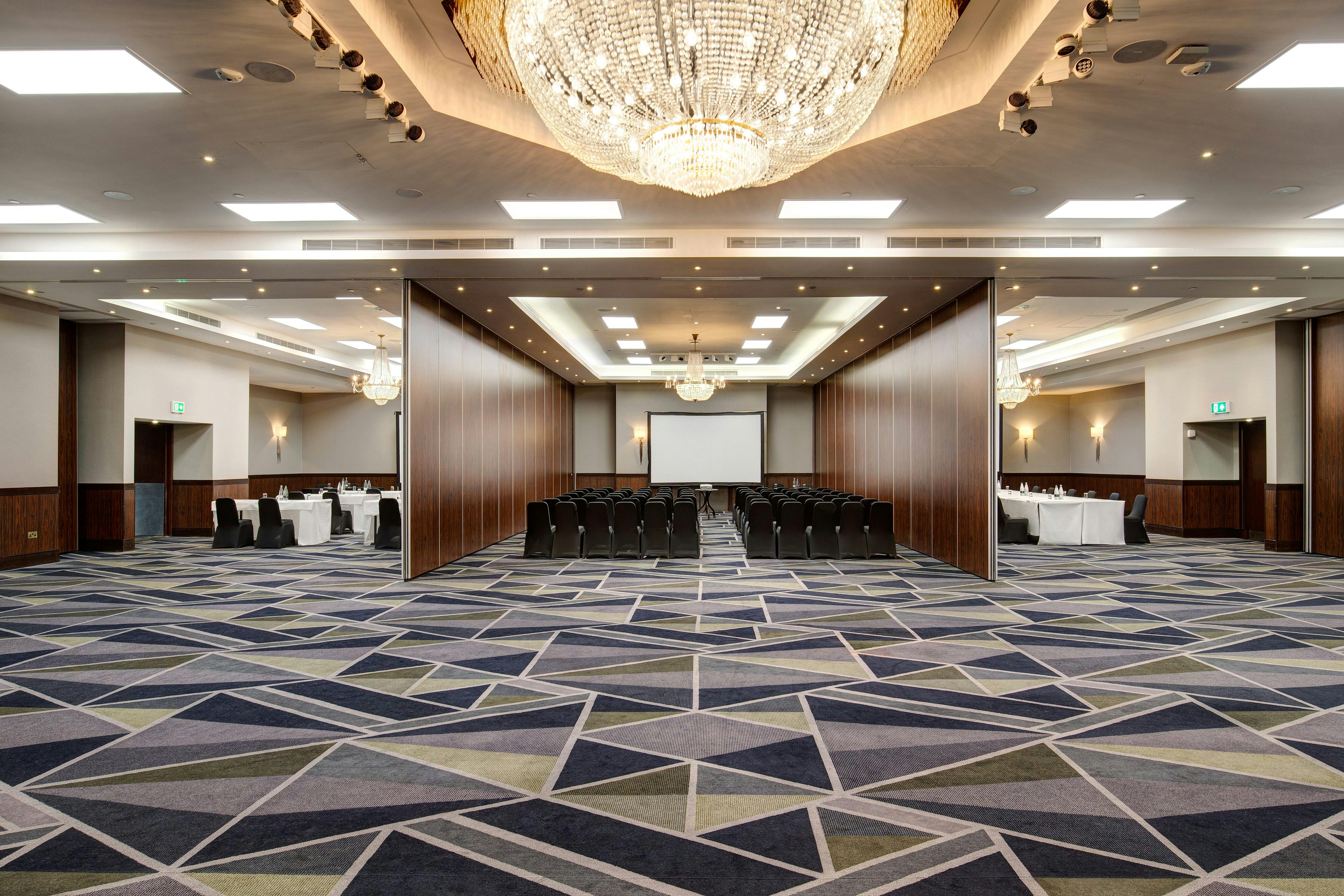 Galleon Total event space with elegant chandelier for corporate meetings and banquets.