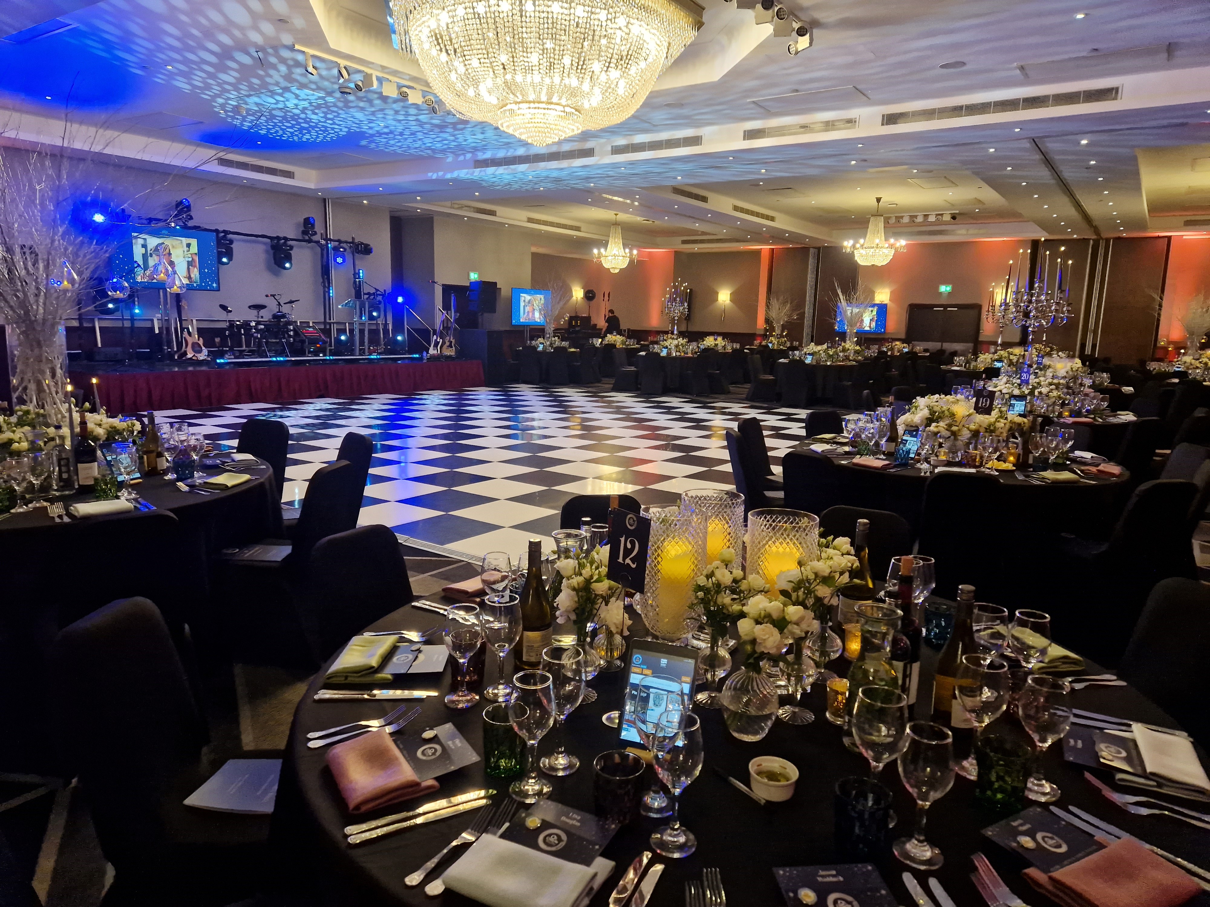 Elegant banquet hall with checkered dance floor for gala or corporate event. - Banner