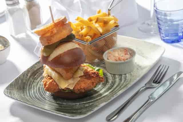 Gourmet burger presentation in The Stuart Hotel meeting room for networking events.