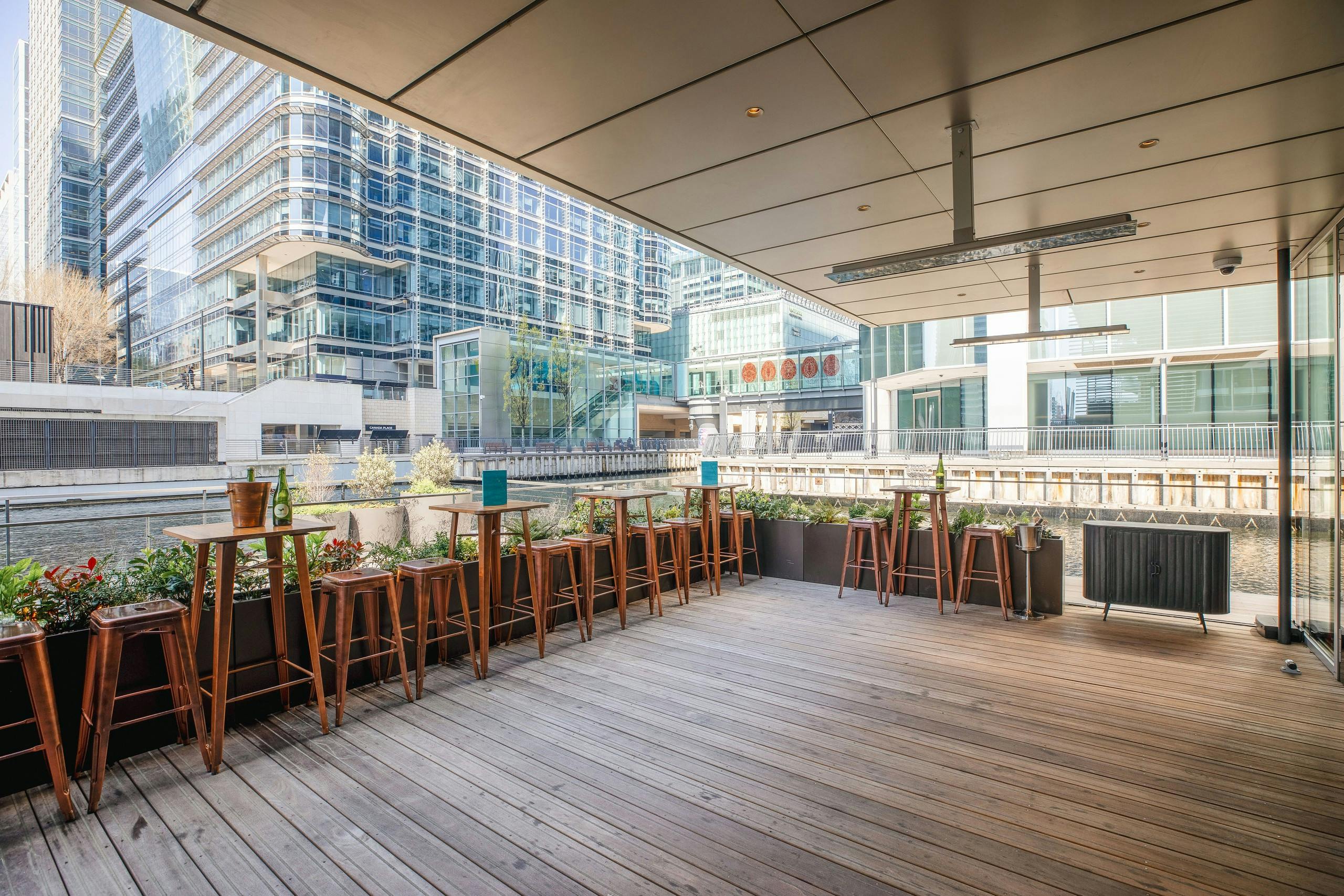 Hawksmoor Bar Summer Terrace with sleek wooden flooring, ideal for outdoor networking events.