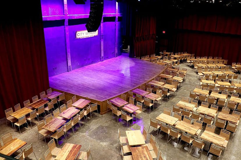 River Level at City Winery NYC, versatile event space with wooden tables for meetings and banquets.
