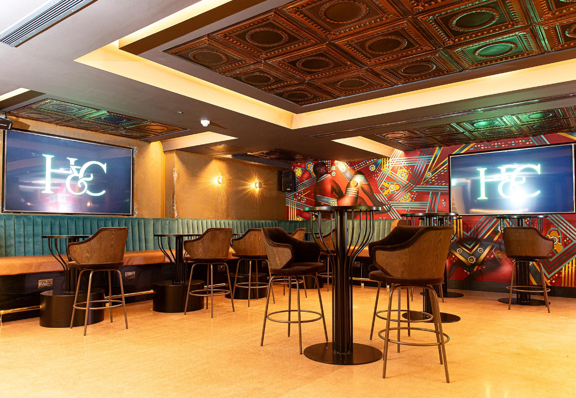 Modern event space with stylish bar seating, perfect for networking and cocktail receptions.