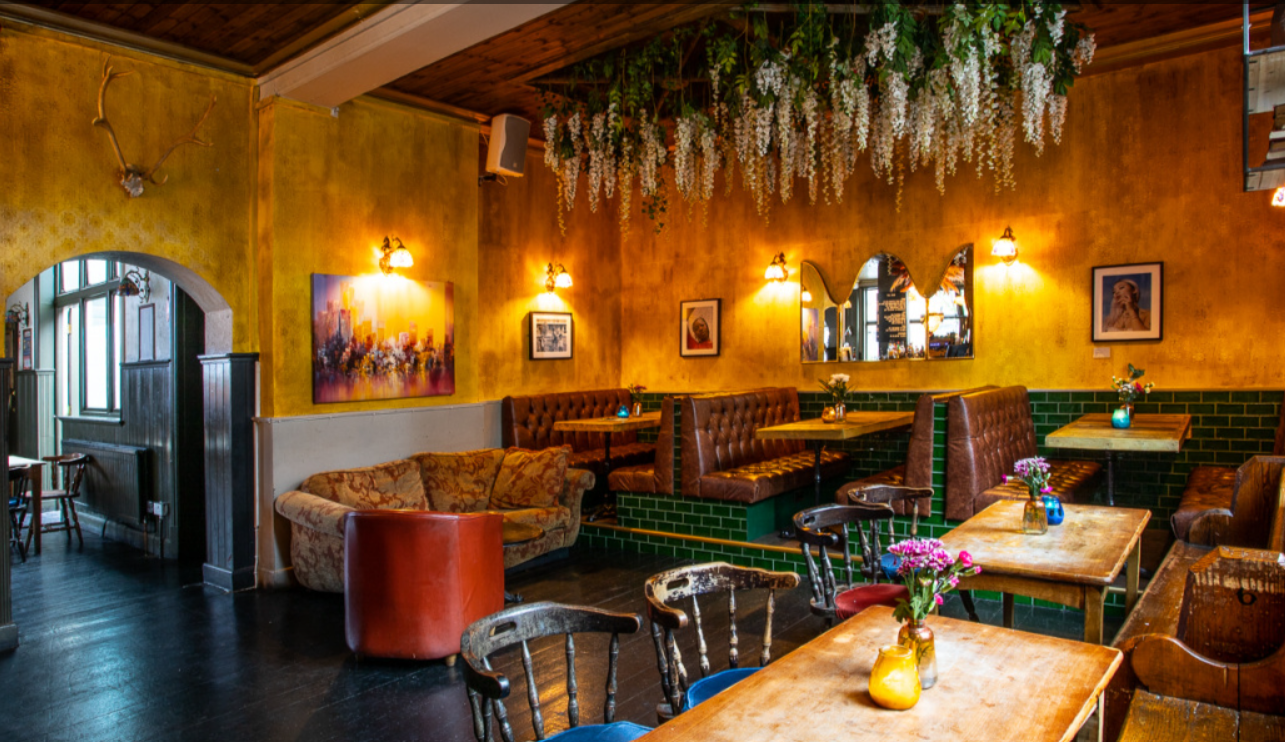 Charming venue with cozy seating for intimate gatherings and networking events. - Banner
