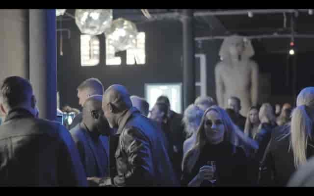 Vibrant networking event in The Den's stylish Main Room with modern decor.