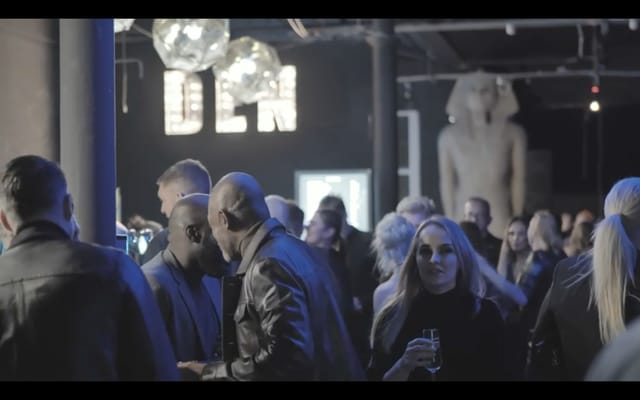 Vibrant networking event in The Den's stylish Main Room with modern decor.