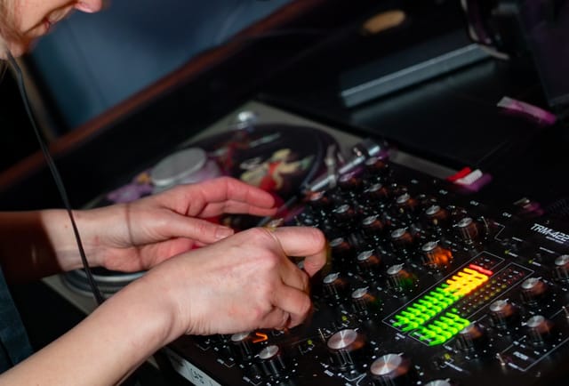 DJ mixing tracks at Private hire event in Hen's Teeth, showcasing vibrant audio atmosphere.