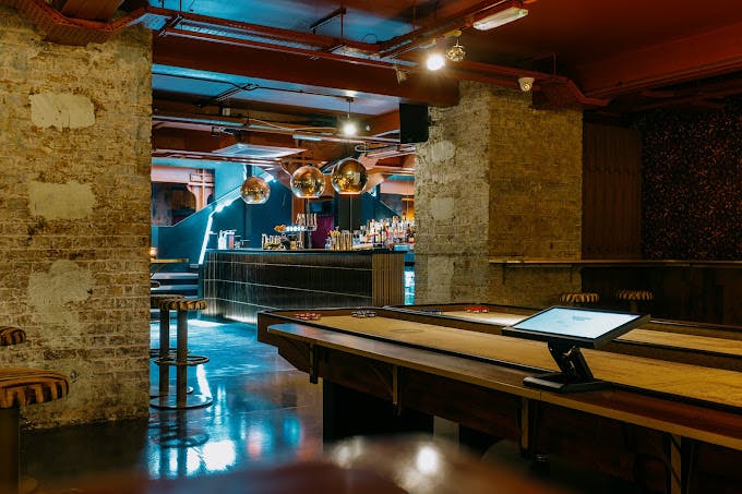 Stylish Shuffle Club event space with exposed brick, perfect for gatherings and networking.