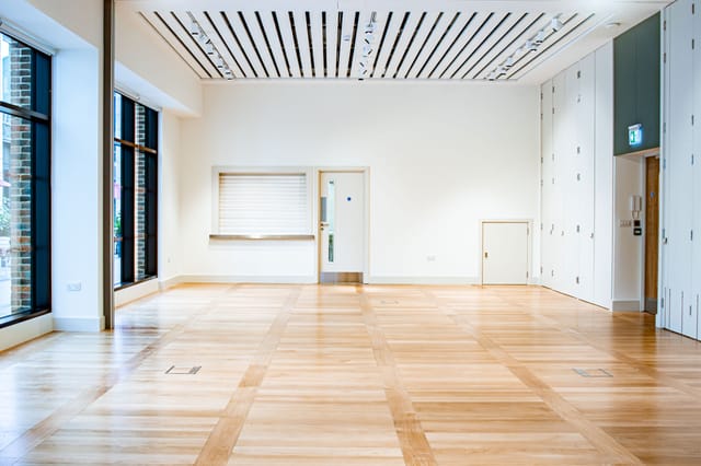 Versatile event space with natural light, ideal for workshops and presentations.