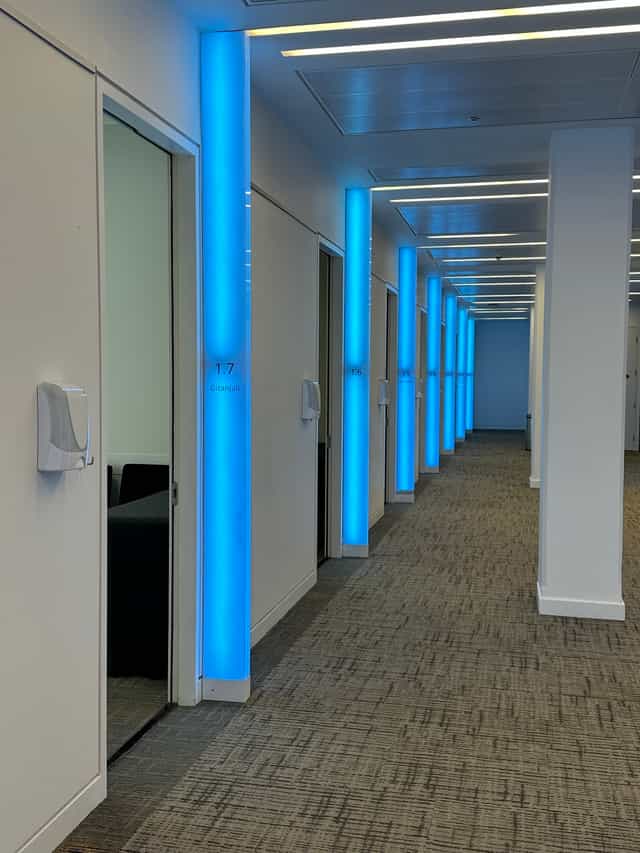 Modern corridor at Scenario Assessment Centre with blue lighting, ideal for corporate events.