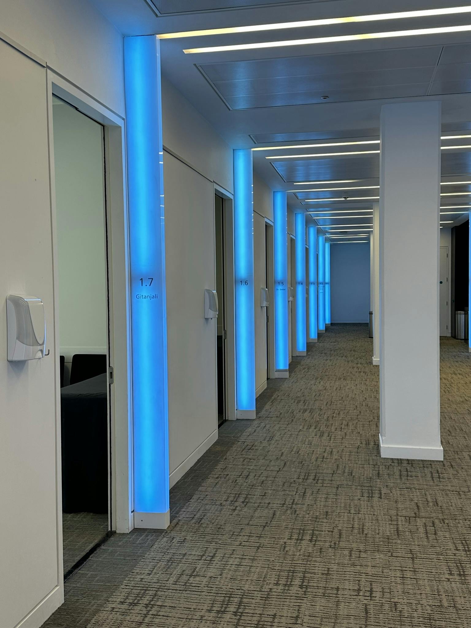 Modern corridor at Scenario Assessment Centre with blue lighting, ideal for corporate events.