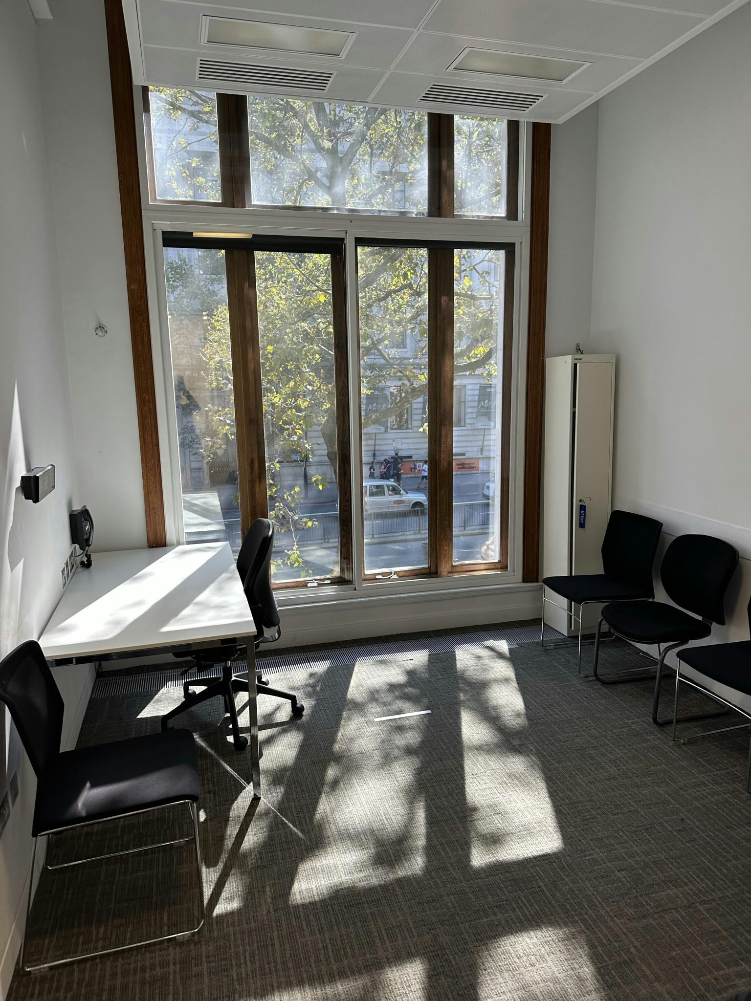 Bright minimalist meeting space with large windows at Scenario Assessment and Learning Centre.