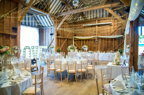 Tythe Barn Tewin Bury Farm wedding venue with rustic beams and elegant decor. - Banner