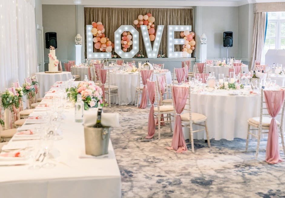 Elegant wedding venue at Thundridge with a large "LOVE" display and pastel decor.