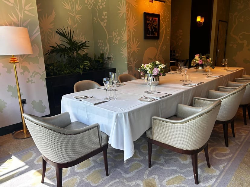 Private meeting room at The River Restaurant, elegant table with floral centerpieces.
