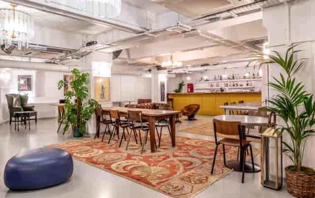 Versatile event space at Pizza East with warm decor, ideal for meetings and gatherings.