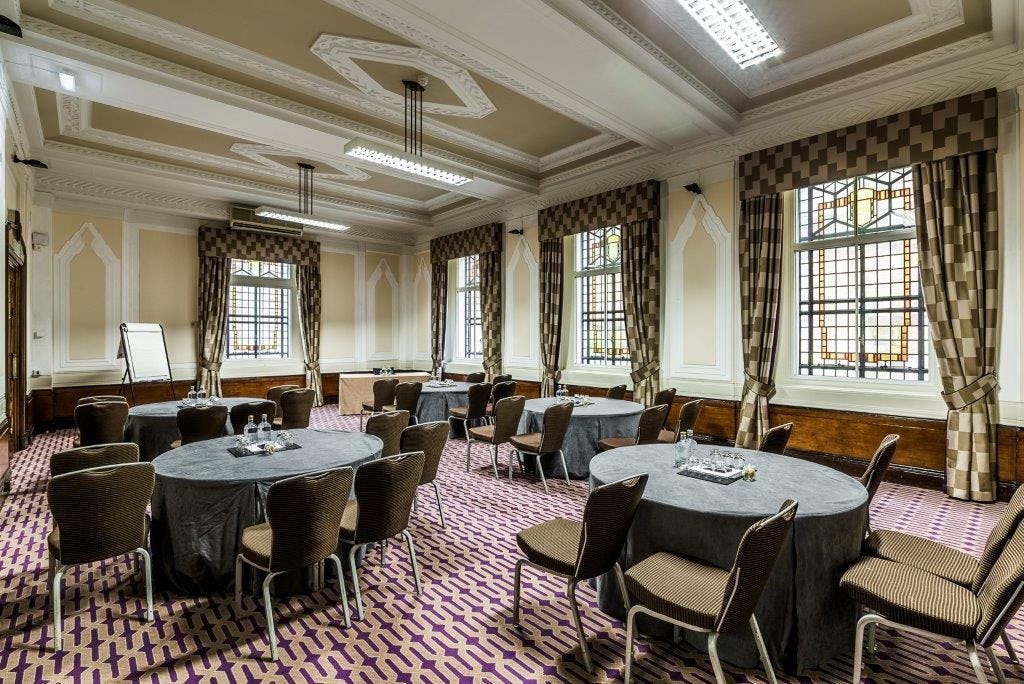 Ulster Suite meeting room with round tables for events and networking at De Vere Grand Connaught Rooms.