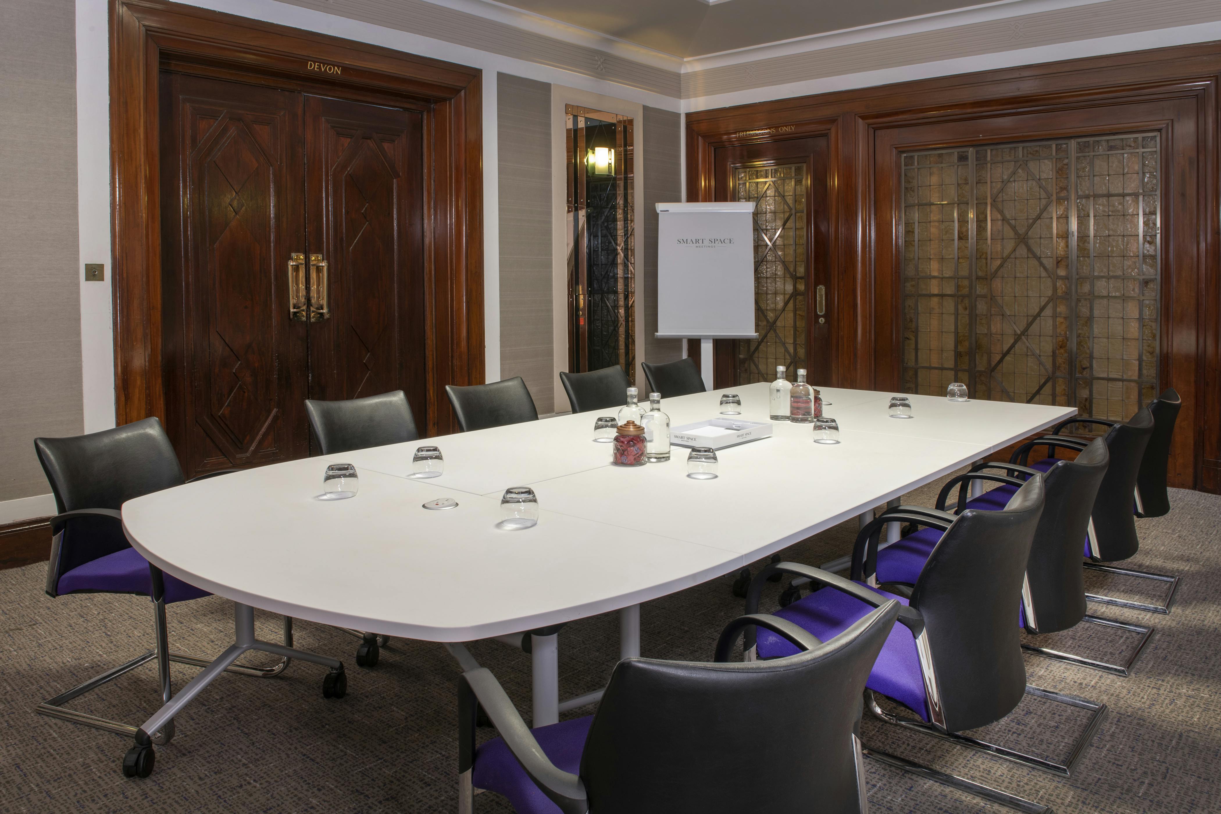 Norfolk Suite meeting room with oval table, ideal for professional workshops and gatherings.