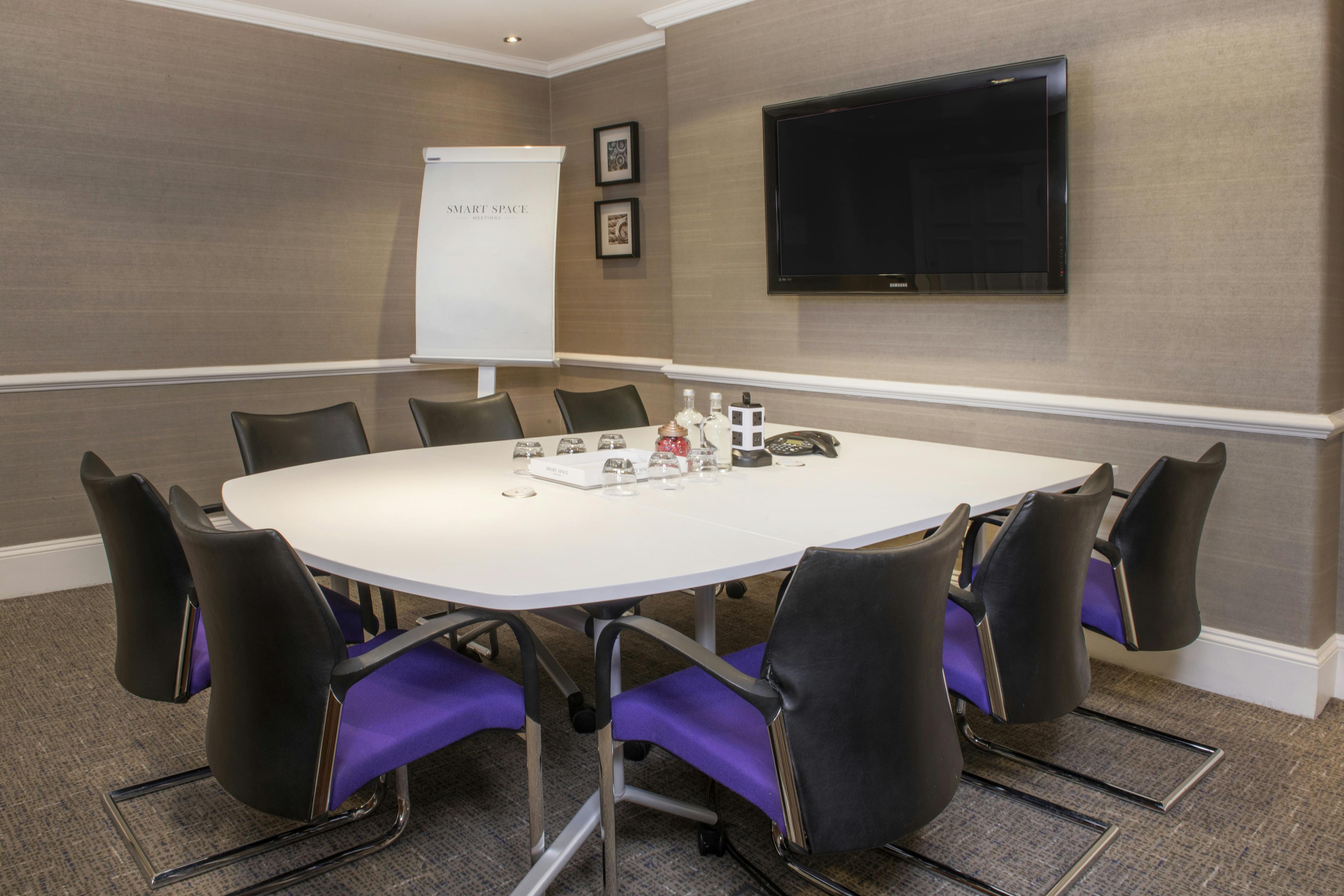 Modern meeting room with round table for collaboration at De Vere Grand Connaught Rooms.