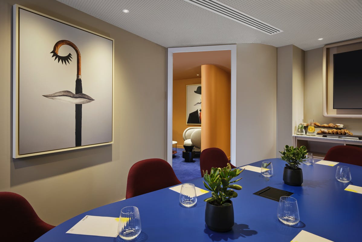 Modern meeting room with vibrant blue table for creative brainstorming at art'otel London.