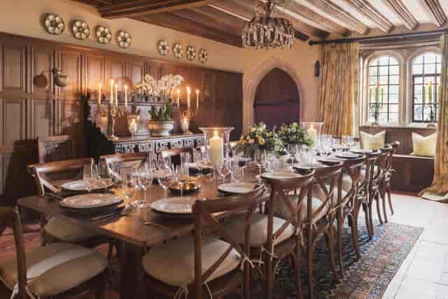 Battel Hall banquet setup at Leeds Castle for luxury corporate dinners and VIP retreats.