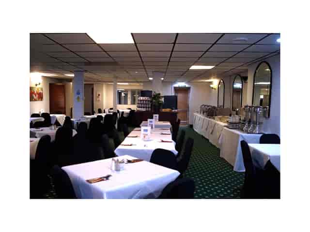 Meeting Room 1 at Bluewaters Hotel with elegant tables, ideal for events and meetings.