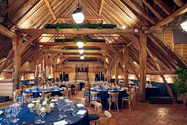 Fairfax Barn at Leeds Castle with timber beams, ideal for luxury weddings and corporate galas.