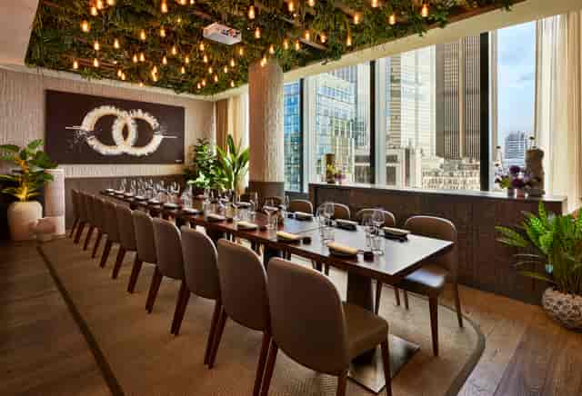 Sophisticated private dining room with long table for corporate meetings and exclusive events.