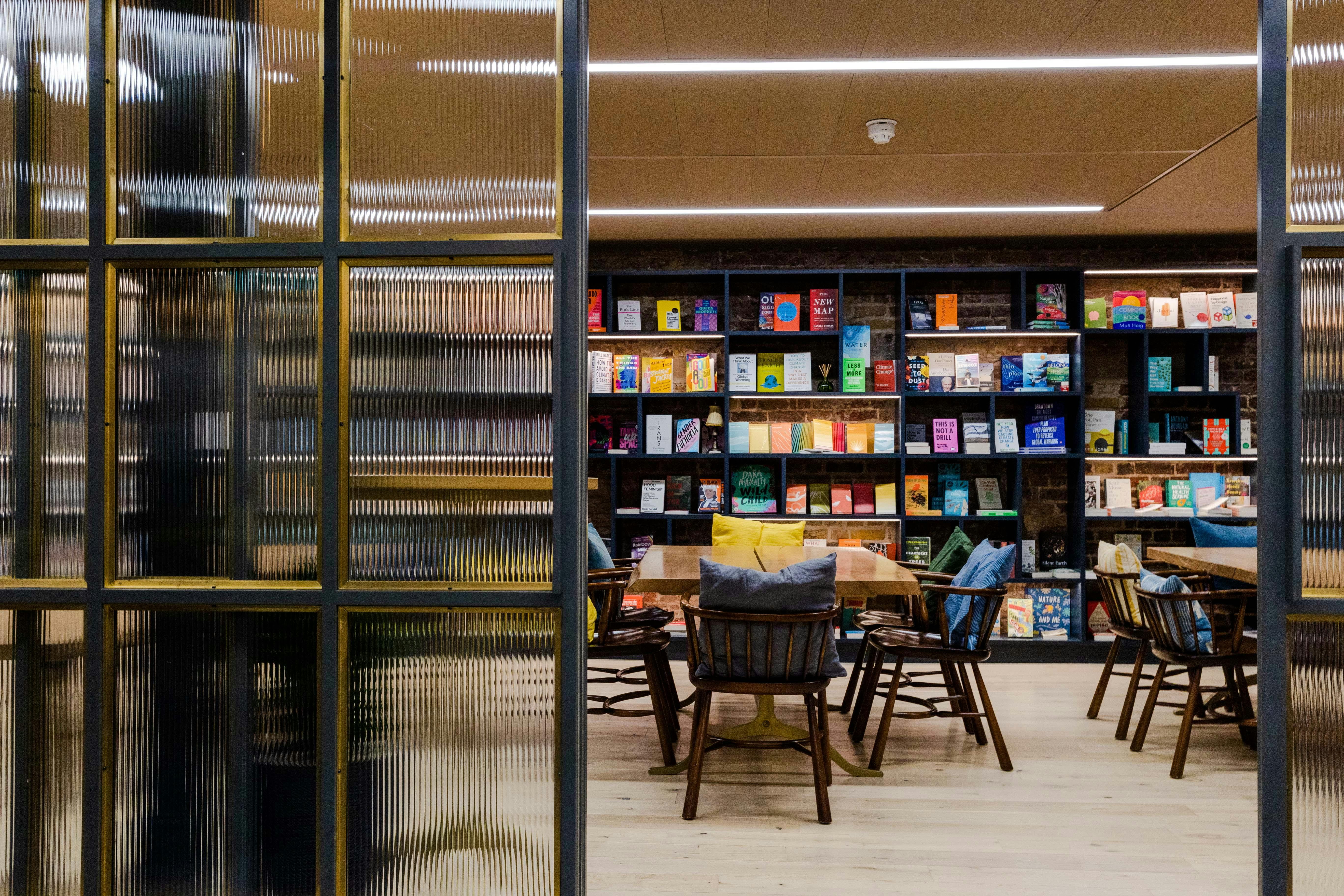 Modern meeting space with colorful bookshelves for workshops and brainstorming sessions.