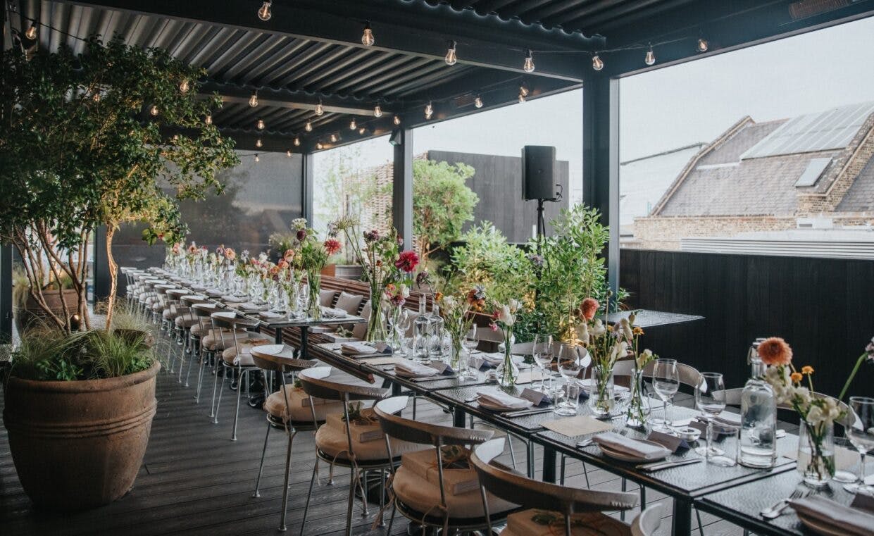 Elegant outdoor event space with floral centerpieces, ideal for upscale gatherings.