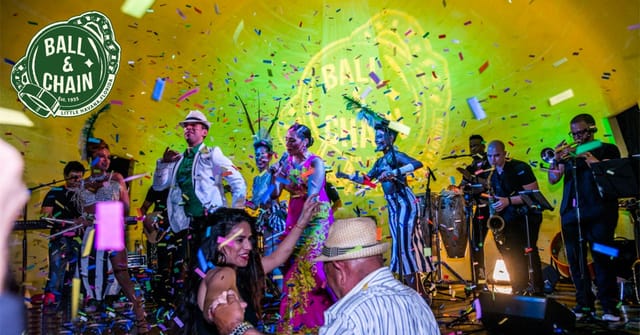 Vibrant bar event at Ball & Chain with lively performers and colorful confetti.