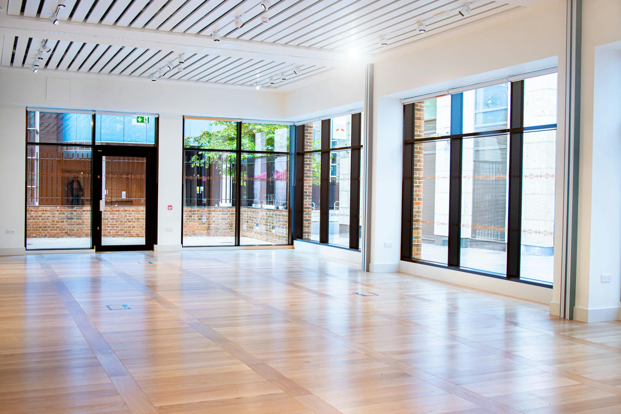 Spacious event space with large windows in The Aldgate Centre, perfect for meetings and gatherings.