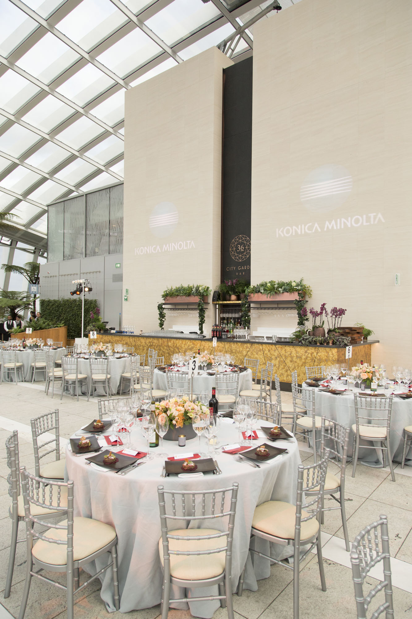 Elegant event space in Sky Garden London with floral centerpieces for corporate gatherings. - Banner