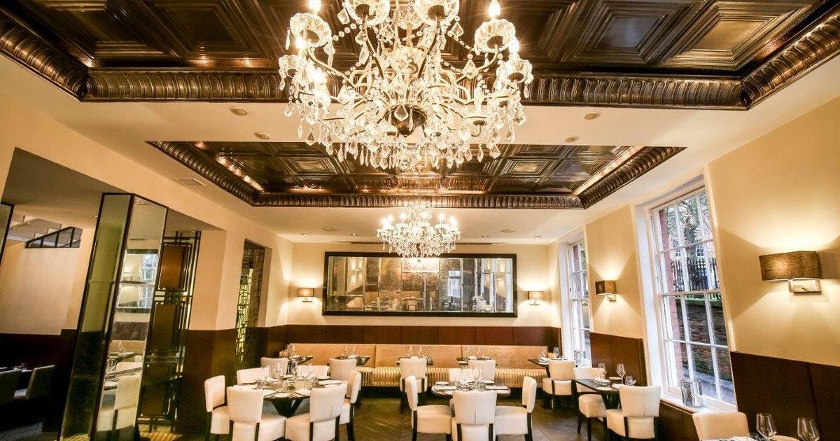 Elegant dining space with chandeliers for upscale corporate events in Lace Market Hotel.