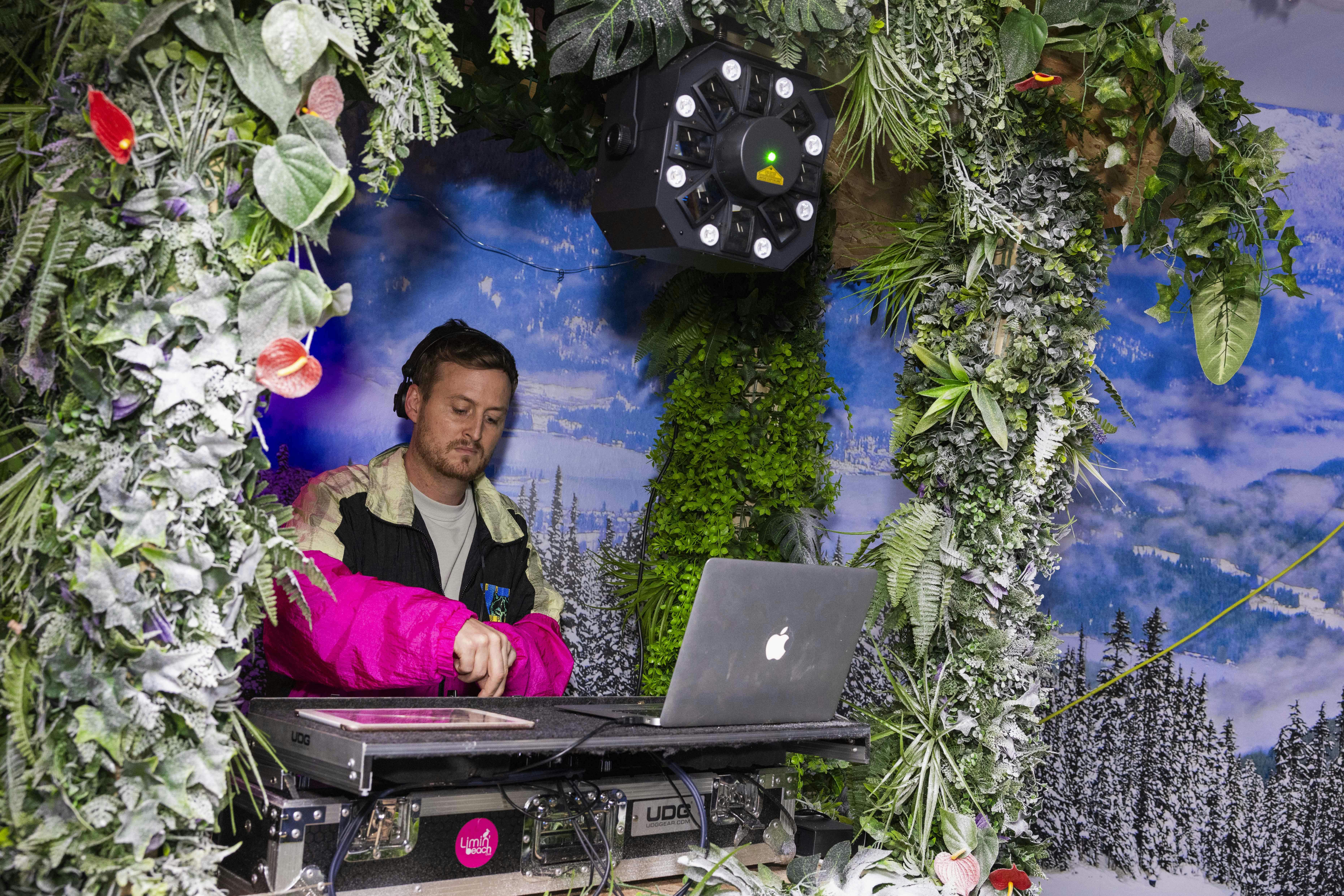 DJ L'Shamonix performing in a lush, nature-inspired setting at LIMIN Southbank event.