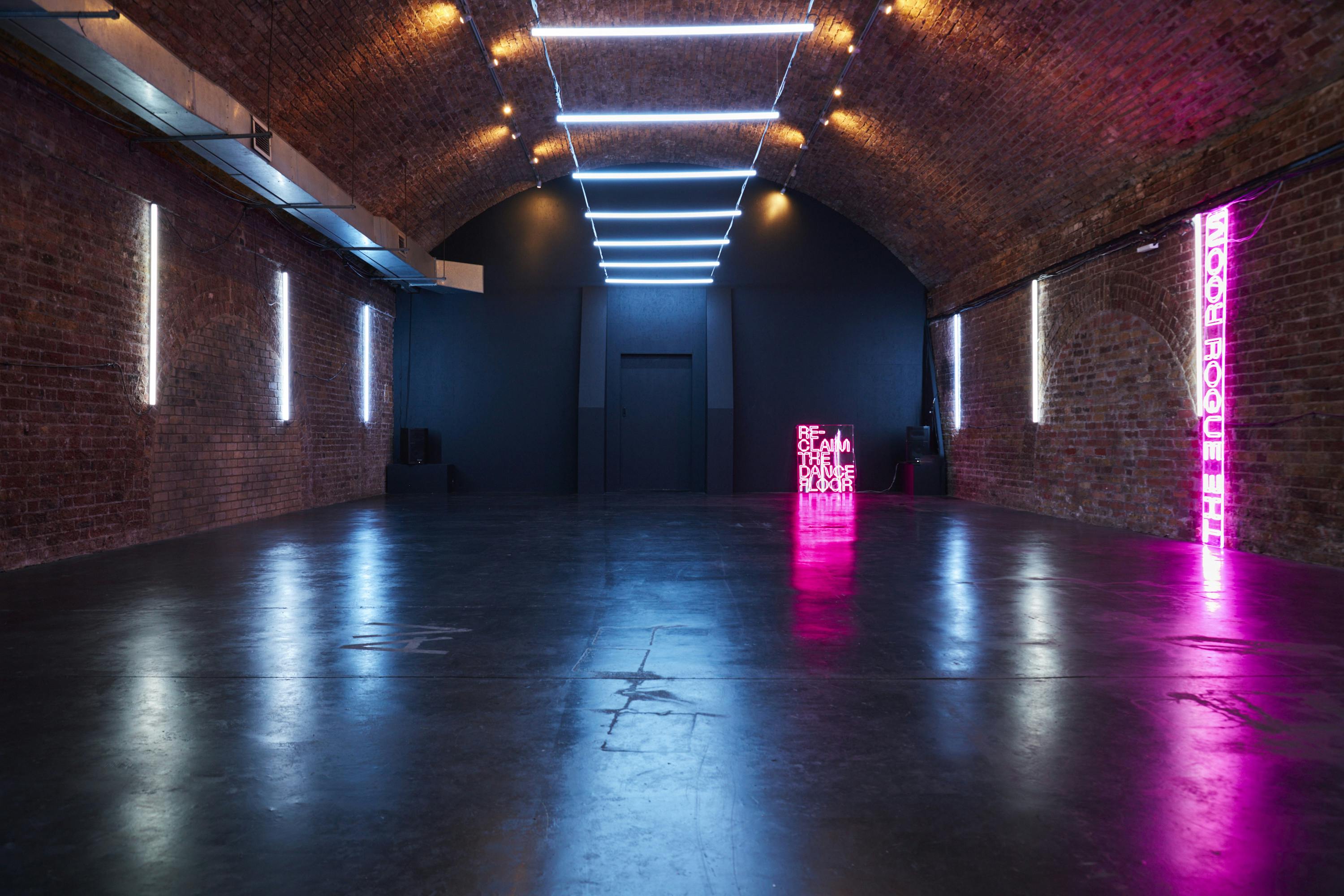 Versatile event space with exposed brick, ideal for corporate and social gatherings.