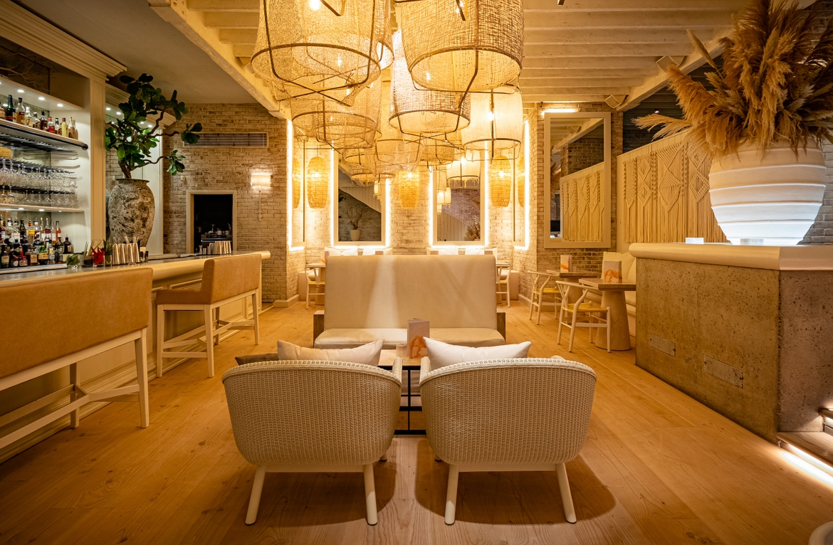 Stylish venue with warm lighting for intimate gatherings and networking events. - Banner