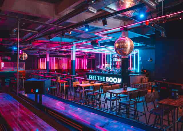 "Vibrant private hire event space with neon lighting at Boom Battle Bar Leeds."