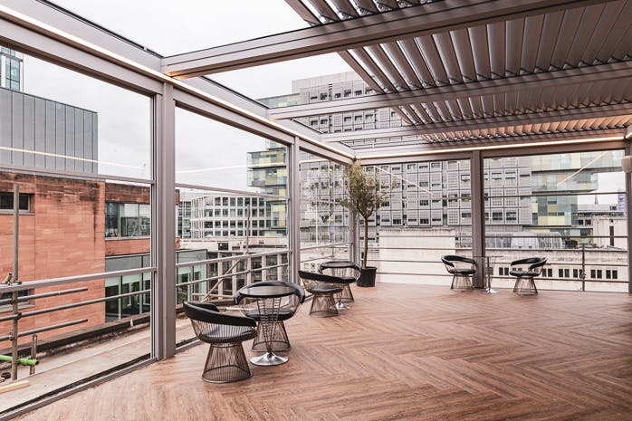 Modern event space in Manchester Hall with large glass panels for natural light.