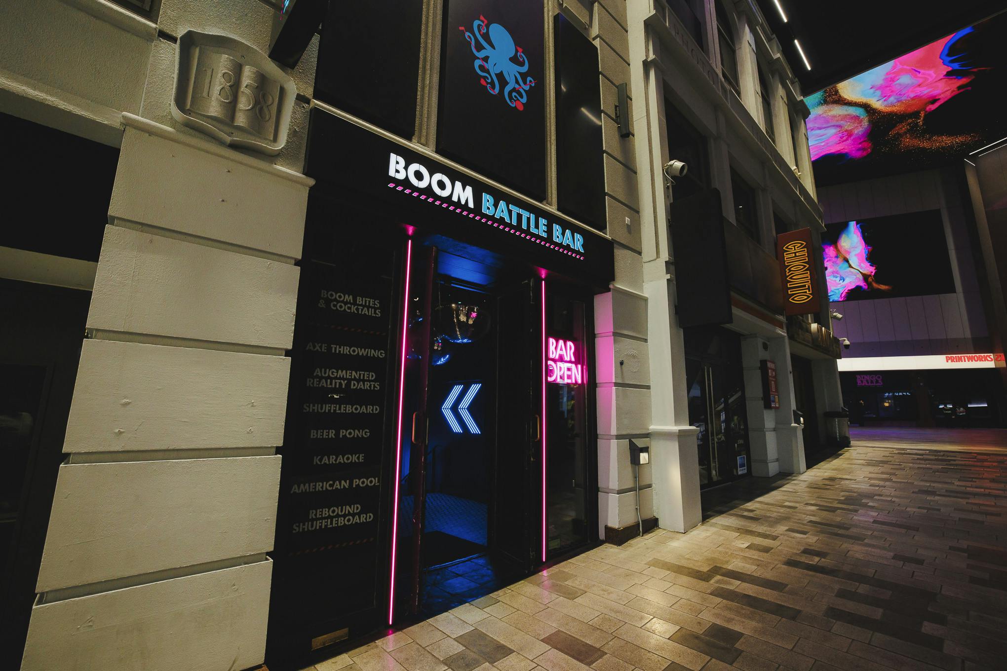 "Boom Battle Bar Manchester entrance with neon signage for team-building events"