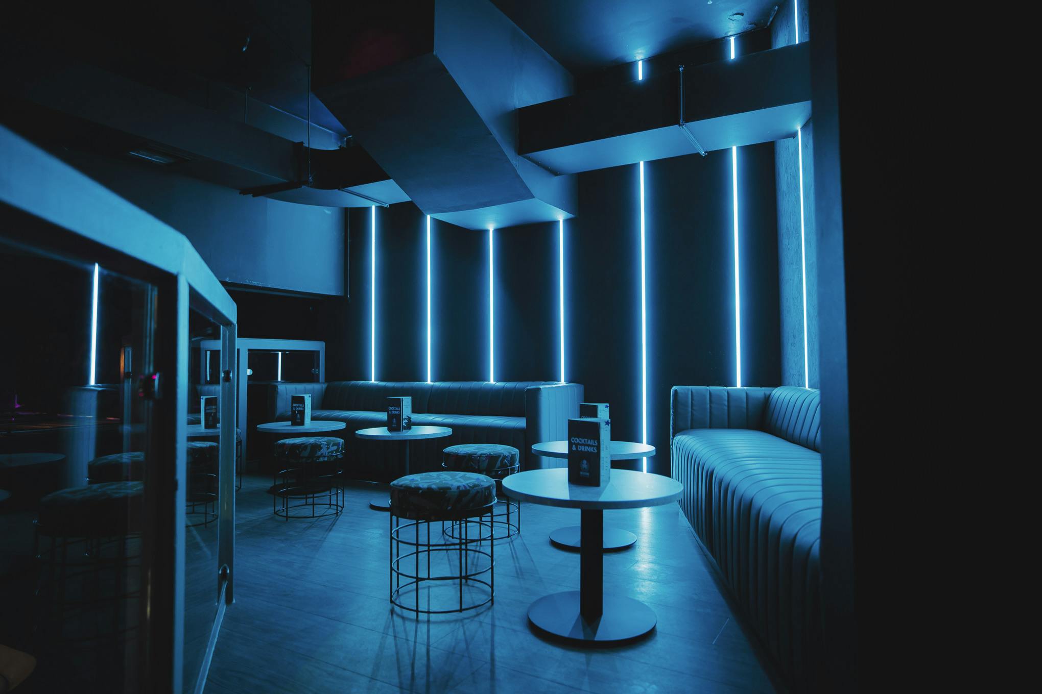 Party Packages at Boom Battle Bar Manchester, modern venue with blue lighting for events.