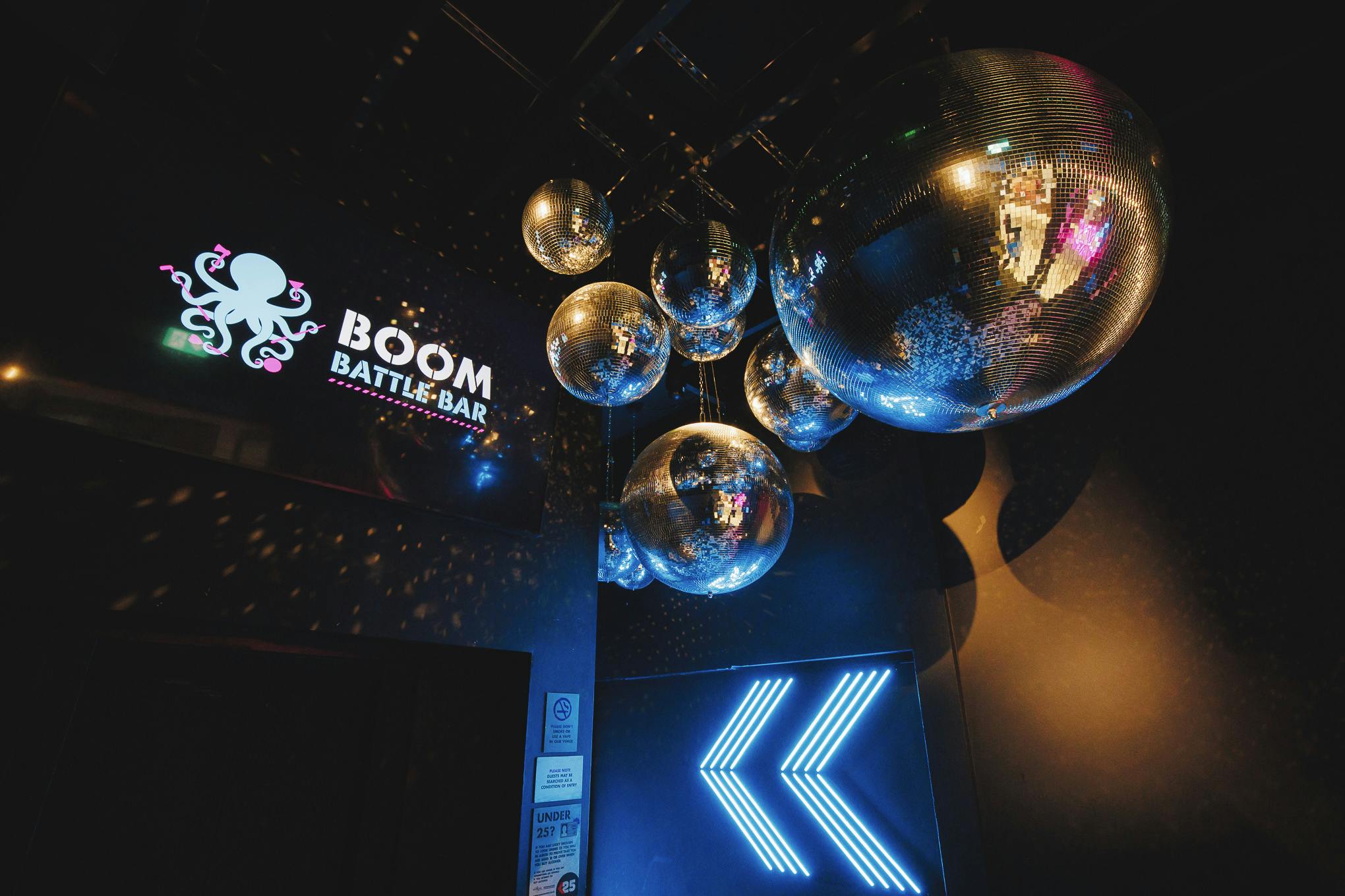 Vibrant Boom Battle Bar Manchester event space with disco balls for team-building parties.